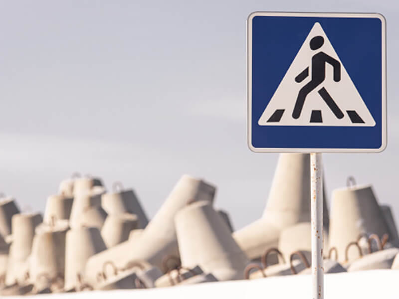 Дорожный знак на фоне конструкций.